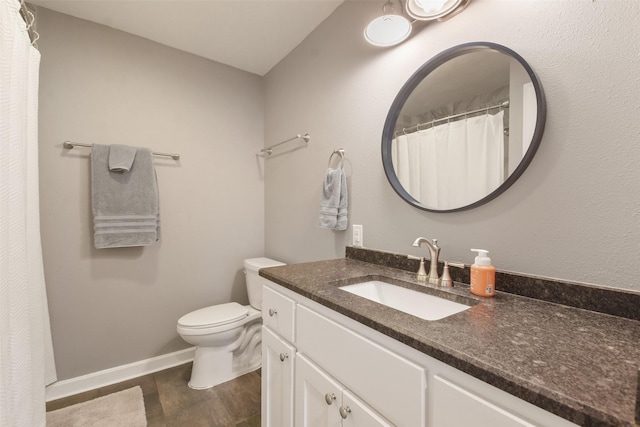 4620 Springfield Ln, Brenham, TX 77833 - bathroom with vanity, toilet, wood finished floors, and baseboards