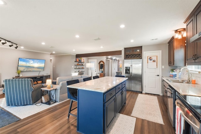 4620 Springfield Ln, Brenham, TX 77833 - kitchen with stainless steel refrigerator with ice dispenser, a sink, open floor plan, dark wood finished floors, and a center island