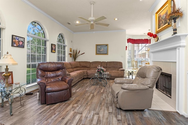 529 Stephen F Austin Dr, Conroe, TX 77302 - living area featuring wood finished floors, a ceiling fan, crown molding, recessed lighting, and a tiled fireplace