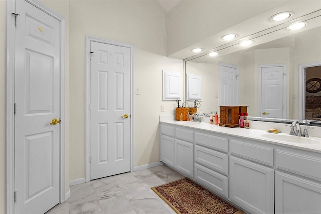 529 Stephen F Austin Dr, Conroe, TX 77302 - full bath featuring double vanity, marble look tile flooring, recessed lighting, vaulted ceiling, and baseboards