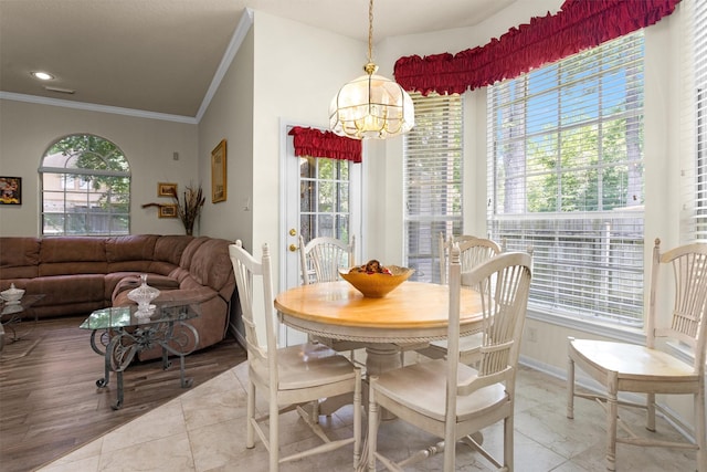 529 Stephen F Austin Dr, Conroe, TX 77302 - tiled dining area featuring crown molding, plenty of natural light, a chandelier, and baseboards