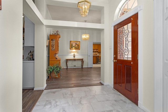 529 Stephen F Austin Dr, Conroe, TX 77302 - foyer entrance featuring a chandelier, marble finish floors, and baseboards
