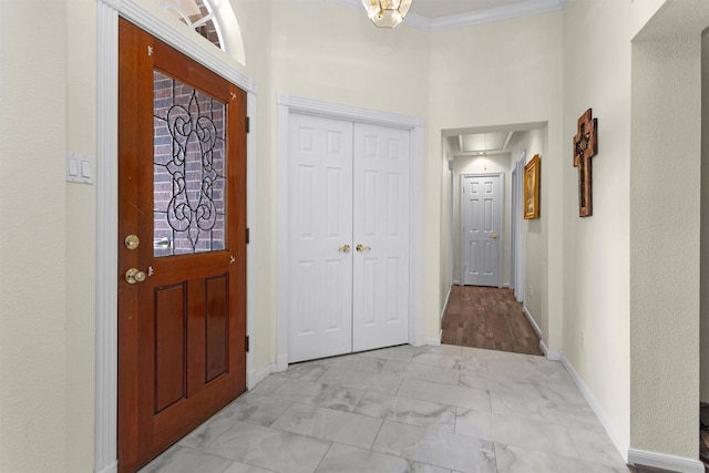 529 Stephen F Austin Dr, Conroe, TX 77302 - entryway featuring light marble finish floors, ornamental molding, and baseboards