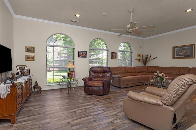 529 Stephen F Austin Dr, Conroe, TX 77302 - living room with wood finished floors, ceiling fan, recessed lighting, ornamental molding, and baseboards