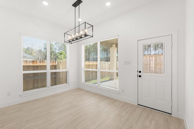 17051 Lilac Paxton Ln, Hockley, TX 77447 - unfurnished dining area with a chandelier, light wood-style flooring, baseboards, and recessed lighting
