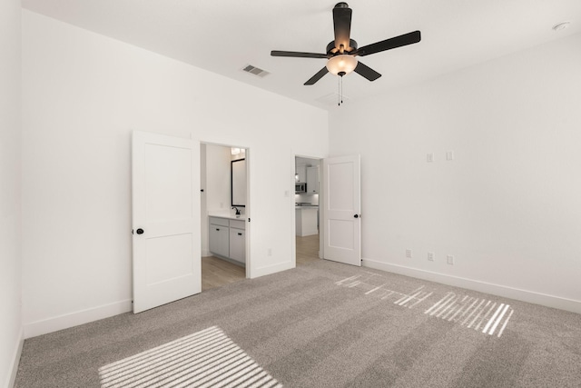 17051 Lilac Paxton Ln, Hockley, TX 77447 - unfurnished bedroom with light colored carpet, baseboards, connected bathroom, and ceiling fan