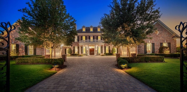 31 Southern Crescent Ct, The Woodlands, TX 77380 - colonial inspired home with decorative driveway, a balcony, brick siding, and a front yard