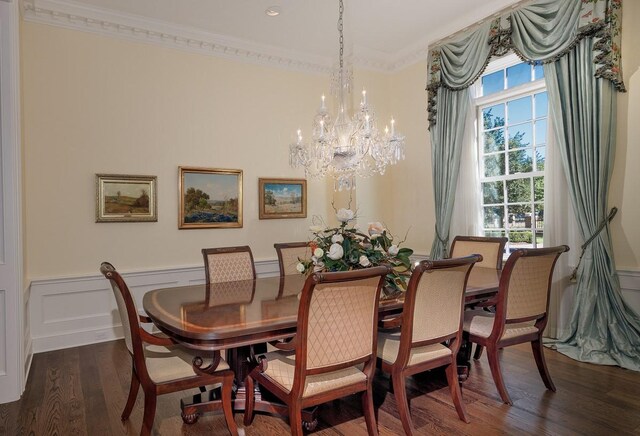 31 Southern Crescent Ct, The Woodlands, TX 77380 - dining room featuring crown molding, a chandelier, wood finished floors, and wainscoting