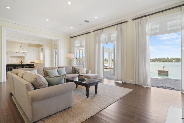 31 Southern Crescent Ct, The Woodlands, TX 77380 - living room with dark wood-style floors, recessed lighting, crown molding, a chandelier, and baseboards