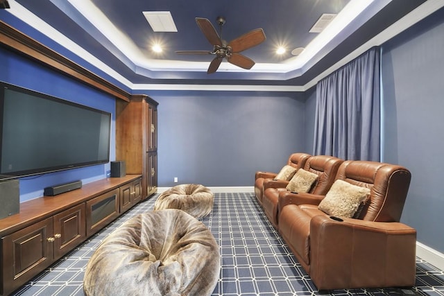 31 Southern Crescent Ct, The Woodlands, TX 77380 - home theater featuring a ceiling fan, a tray ceiling, baseboards, dark carpet, and recessed lighting