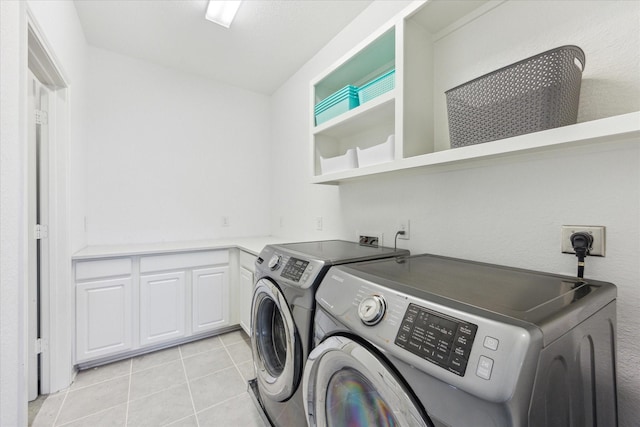 9650 Caddo Ridge Ln, Cypress, TX 77433 - washroom with washing machine and clothes dryer and light tile patterned flooring