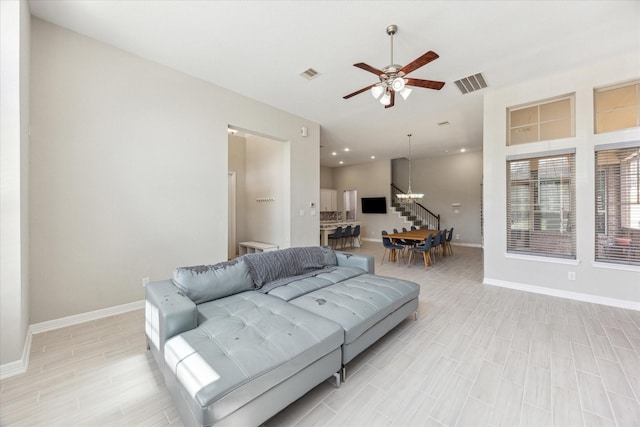 9650 Caddo Ridge Ln, Cypress, TX 77433 - living room with ceiling fan, baseboards, a chandelier, and light wood-style flooring