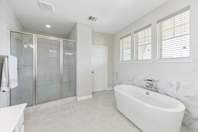 9650 Caddo Ridge Ln, Cypress, TX 77433 - full bathroom featuring a freestanding bath, a shower stall, vanity, and tile patterned floors