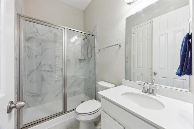 9650 Caddo Ridge Ln, Cypress, TX 77433 - full bath with a marble finish shower, toilet, a textured wall, vanity, and tile patterned floors