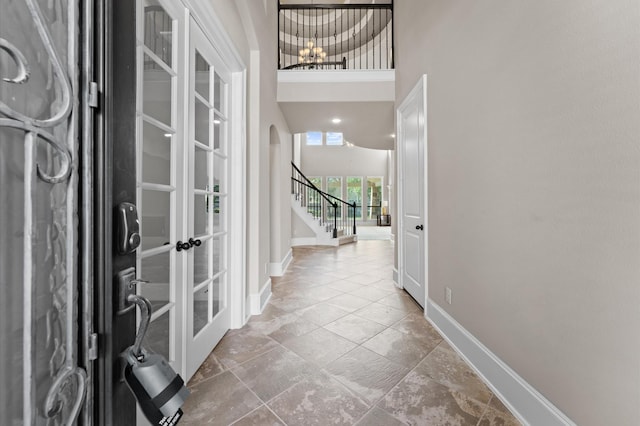10115 Cypress Path, Missouri City, TX 77459 - foyer with french doors, stairway, baseboards, a chandelier, and arched walkways