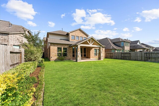 10115 Cypress Path, Missouri City, TX 77459 - rear view of house featuring a patio, brick siding, and roof with shingles