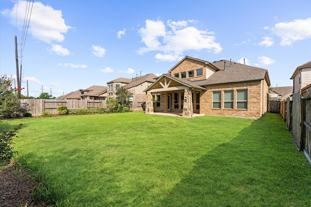 10115 Cypress Path, Missouri City, TX 77459 - back of house featuring brick siding, a patio, and roof with shingles