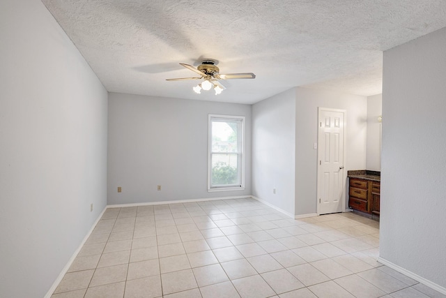 3826 Brier Gardens Dr, Houston, TX 77082 - empty room featuring ceiling fan, a textured ceiling, light tile patterned floors, and baseboards