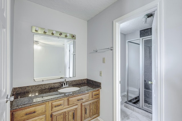3826 Brier Gardens Dr, Houston, TX 77082 - full bath featuring a textured ceiling, vanity, a shower stall, toilet, and tile patterned floors
