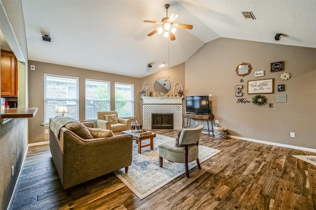 2957 Water Willow Ln, Pearland, TX 77581 - living area with dark wood-style floors, lofted ceiling, ceiling fan, and a tile fireplace