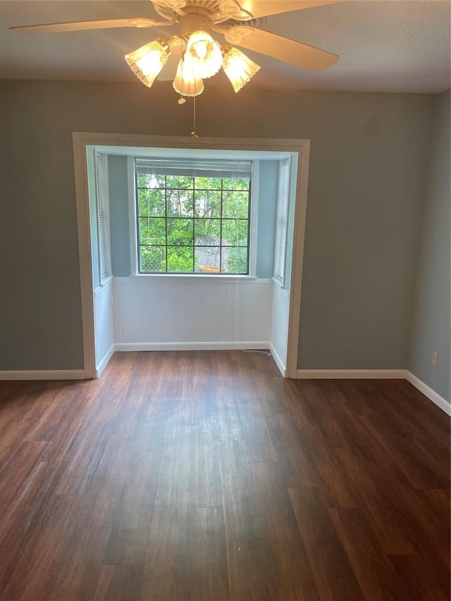 325 E Main St, Brenham, TX 77833 - spare room with ceiling fan and dark wood-type flooring
