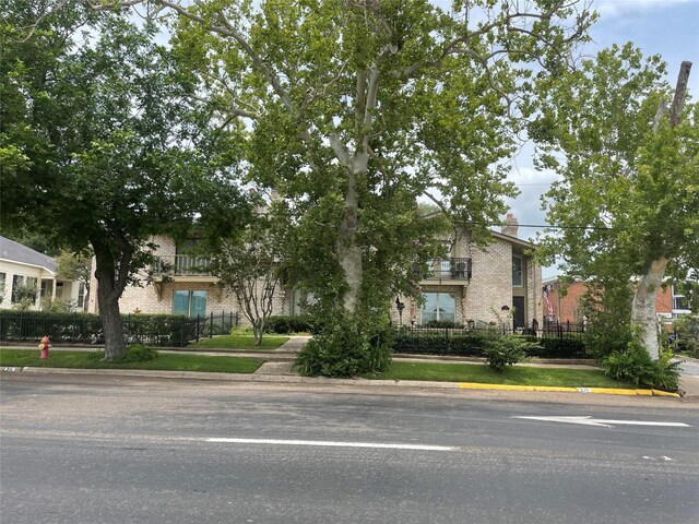 325 E Main St, Brenham, TX 77833 - obstructed view of property featuring brick siding