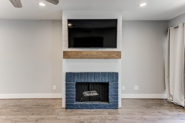 12100 Melville Dr Unit 606, Montgomery, TX 77356 - detailed view of wood finished floors, baseboards, recessed lighting, and a fireplace