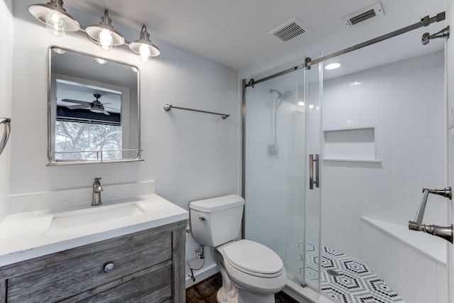 12100 Melville Dr Unit 606, Montgomery, TX 77356 - full bathroom with a shower stall, vanity, toilet, ceiling fan, and wood finished floors