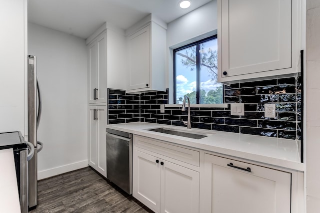 12100 Melville Dr Unit 606, Montgomery, TX 77356 - kitchen with a sink, stainless steel dishwasher, baseboards, backsplash, and dark wood-style flooring