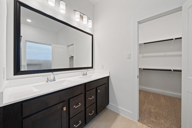17055 Lilac Paxton Ln, Hockley, TX 77447 - full bath with double vanity, baseboards, and a walk in closet