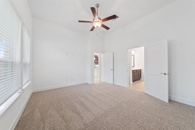 17055 Lilac Paxton Ln, Hockley, TX 77447 - unfurnished bedroom with light colored carpet, multiple windows, baseboards, and a towering ceiling