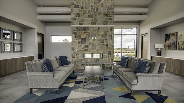 17055 Lilac Paxton Ln, Hockley, TX 77447 - living room featuring finished concrete flooring, a high ceiling, and a fireplace