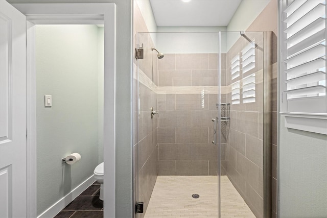 2811 Izamal Ct, Galveston, TX 77554 - full bath featuring a shower stall, toilet, baseboards, and tile patterned floors