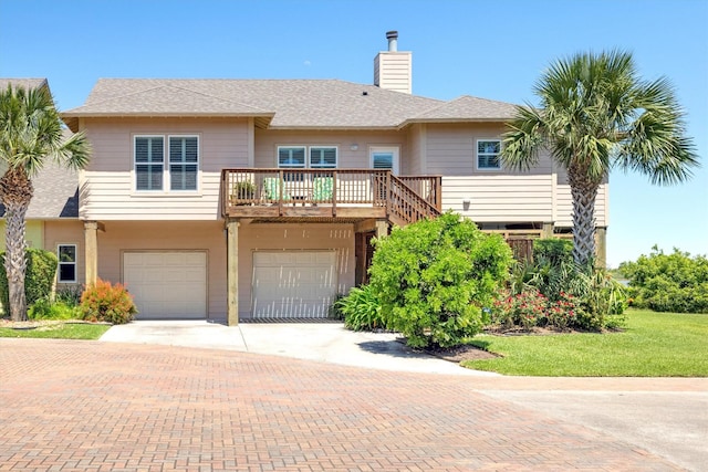 2811 Izamal Ct, Galveston, TX 77554 - multi unit property featuring a chimney, decorative driveway, a garage, and a front yard