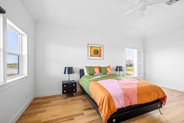 2811 Izamal Ct, Galveston, TX 77554 - bedroom with light wood-style flooring, baseboards, and a ceiling fan