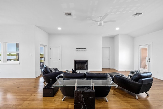 2811 Izamal Ct, Galveston, TX 77554 - living room with a fireplace, wood finished floors, a ceiling fan, baseboards, and recessed lighting