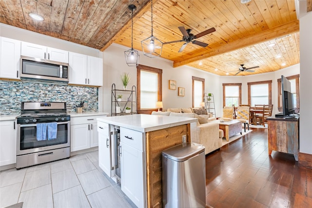 1828 Ursuline St, Galveston, TX 77550 - kitchen featuring appliances with stainless steel finishes, wood ceiling, light countertops, tasteful backsplash, and open floor plan