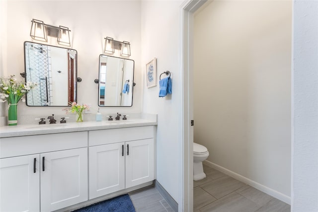 1828 Ursuline St, Galveston, TX 77550 - full bathroom with double vanity, toilet, and baseboards