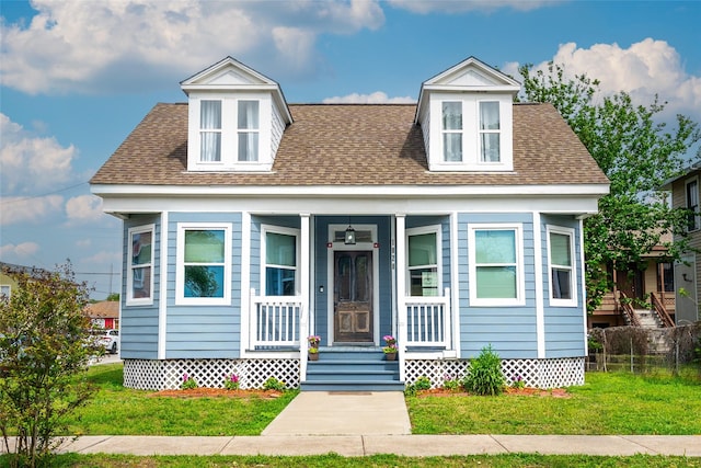 1828 Ursuline St, Galveston, TX 77550 - view of front of house with a front lawn, covered porch, and a shingled roof