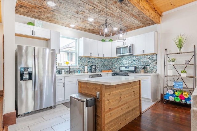 1828 Ursuline St, Galveston, TX 77550 - kitchen featuring stainless steel appliances, wooden ceiling, light countertops, a sink, and white cabinetry