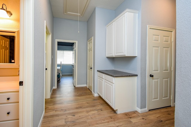 15603 Clear Pointe Dr, Cypress, TX 77429 - corridor featuring attic access, light wood-type flooring, and baseboards