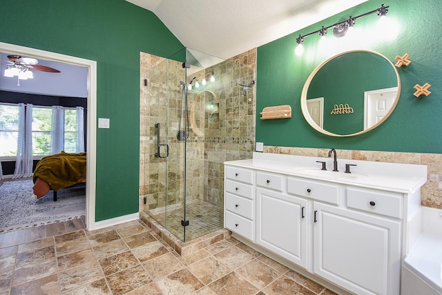 15603 Clear Pointe Dr, Cypress, TX 77429 - ensuite bathroom with vaulted ceiling, ceiling fan, a shower stall, vanity, and stone finish floors