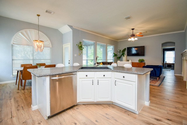 15603 Clear Pointe Dr, Cypress, TX 77429 - kitchen featuring stainless steel dishwasher, a sink, open floor plan, light wood finished floors, and pendant lighting