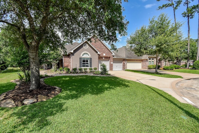 15603 Clear Pointe Dr, Cypress, TX 77429 - view of front of home with driveway, an attached garage, a front lawn, and brick siding