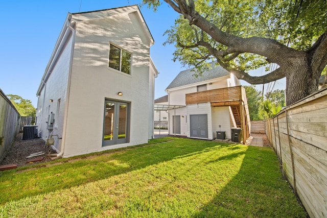 3810 Bellefontaine St, Houston, TX 77025 - back of house with french doors, a fenced backyard, stairs, and stucco siding