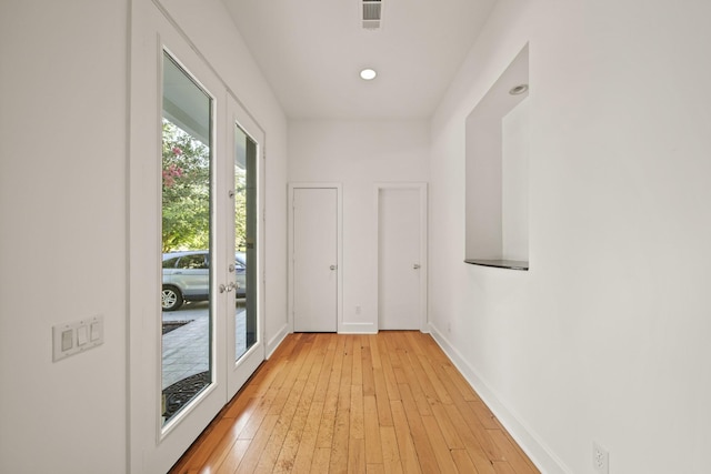 3810 Bellefontaine St, Houston, TX 77025 - entryway featuring french doors, baseboards, and light wood-style flooring