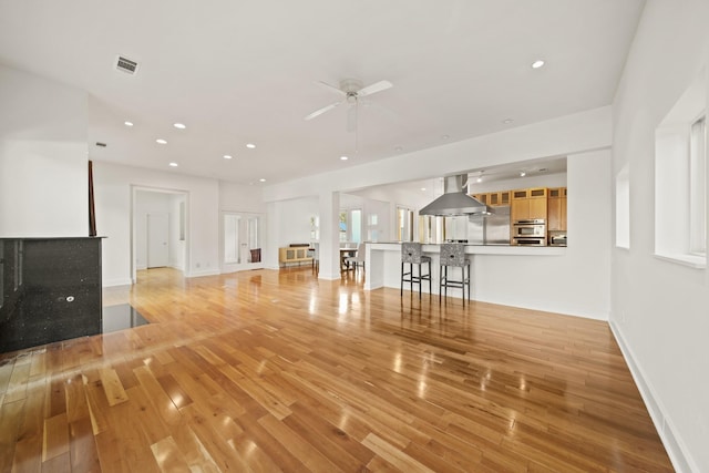 3810 Bellefontaine St, Houston, TX 77025 - unfurnished living room with light wood-style floors, a ceiling fan, recessed lighting, and baseboards