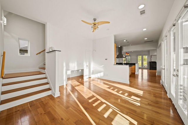 3810 Bellefontaine St, Houston, TX 77025 - unfurnished living room with light wood finished floors, stairway, recessed lighting, baseboards, and ceiling fan