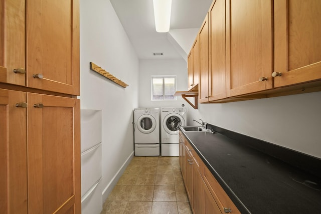 3810 Bellefontaine St, Houston, TX 77025 - washroom featuring washing machine and clothes dryer, cabinet space, light tile patterned flooring, and baseboards