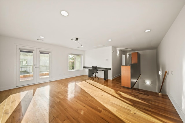 3810 Bellefontaine St, Houston, TX 77025 - unfurnished living room with hardwood / wood-style flooring, french doors, recessed lighting, and baseboards
